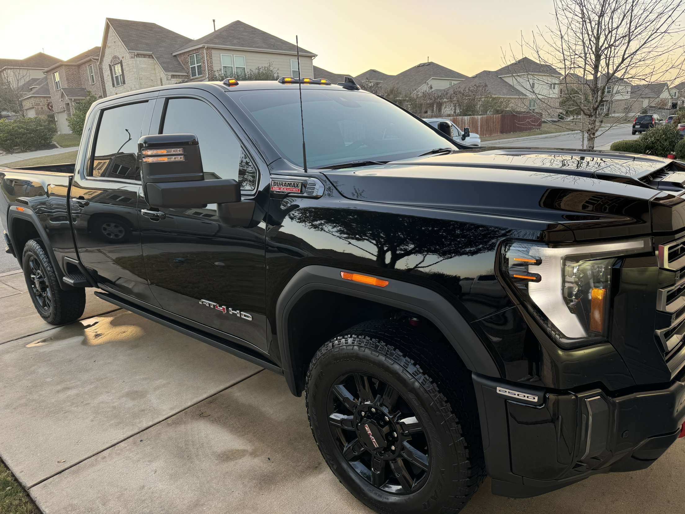 Black GMC Sierra detailed in driveway with ceramic coating